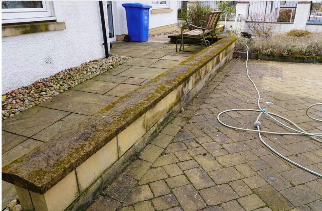 Before patio and driveway cleaning in Stirling - mossy walls and slabs